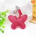 Detail of pink rhinestone butterfly keychain with matching tassel and silver bell - Rose Red