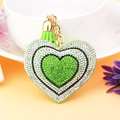 Detailed macro view of heart-shaped keychain with green rhinestones and tassel - Light Green