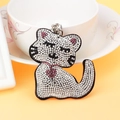 Sparkling cat keychain with white and pink rhinestones on a yellow background - Black With White Rhinestone