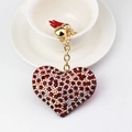 Sparkling heart rhinestone keychain with red tassel and gold metal chain on white cup - Red