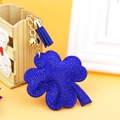Blue four-leaf clover keychain with rhinestones, golden chain, and matching tassel - Sapphire Blue