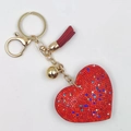 Macro detail of red rhinestone heart keychain with gold plating and silk tassel - Gold Tone + Red Base Mixed Color