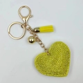 Close-up of yellow rhinestone heart keychain with gold lobster clasp and tassel detail - Gold + Yellow