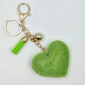 Close-up of green crystal heart keychain with gold hardware and leather tassel - Gold and Fruit Green