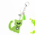 Detail of green rhinestone cat keychain with emerald crystal inlay and silk tassel charm - Green