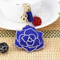 Detailed view of royal blue crystal rose keychain with elegant tassel and gold bell charm - Blue