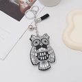 Detail of owl keychain with black and white rhinestones, silver bell and tassel - Black With White Rhinestone