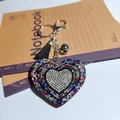 Colorful heart keychain with sparkling rhinestones, black tassel and a small silver bell - Multi-color