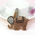 Macro detail of elephant keychain with sparkling rhinestones and a brown tassel - Khaki