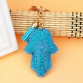 Detailed close-up of a Hamsa hand keychain with purple rhinestones and blue tassel detail - Lake Blue