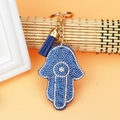 Detail of Hamsa Hand keychain with blue rhinestones and leather tassel on bamboo - Light Blue