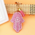 Detailed view of pink Hamsa hand keychain with rhinestones and matching tassel pendant - Pink