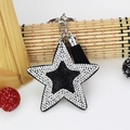 Detail of star-shaped keychain with black and silver rhinestones and a black silk tassel - Black With White Rhinestone