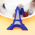 Detailed view of Eiffel Tower keychain featuring blue rhinestones and matching tassel - Blue