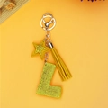 Macro shot of yellow rhinestone letter L keychain with star charm and long fringe tassel - Yellow Letter L Style (P0106)