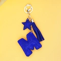 Close-up of blue rhinestone letter M keychain with star pendant and matching tassel - Blue Letter M Style (P0100)