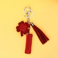 Close-up of red four-leaf clover keychain with sparkling rhinestones and suede tassel - Red Clover Style (P0099)