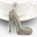 Close-up of sparkling rhinestone high heel keychain hanging on a white coffee cup - Silver + White Base White Rhinestone