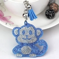 Detail of blue rhinestone monkey keychain with silver bell and matching tassel charm - Light Blue
