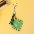 Sparkling green rhinestone letter N keychain with a stylish leather tassel on yellow backdrop - Green Letter N Style (P0107)