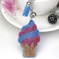 Close-up of crystal ice cream keychain with blue tassel and silver bell detail - Light Blue