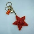 Sternförmiger Schlüsselanhänger in Orange mit Strasssteinen und goldener Quaste für Taschen - 65*65mm / Orange