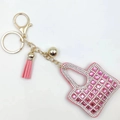 Pink mini bag keychain with square glass crystals and leather tassel on white background - Pink