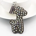 Close-up of sparkling rhinestone teddy bear keychain with purple tassel and metal hook - Dog / Gray