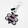 Sparkling pink rhinestone bee keychain with black tassel and silver bell accessory - Pink