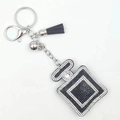Sparkling rhinestone perfume bottle keychain with black tassel and silver charms - Black