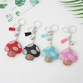 Cute mushroom rhinestone keychain with colorful leather tassels and silver bells - Yellow
