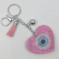 Pink heart evil eye keychain with rhinestones, matching pink tassel, and silver bell accessory - Pink