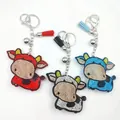 Lot de trois porte-clés vache de dessin animé avec strass, pompons et cloches de couleurs assorties - Multicolore