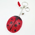 Porte-clés coccinelle étincelant avec strass rouges, pompon en cuir et clochette - Noir + Rouge
