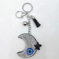 Moon and star rhinestone keychain with blue evil eye charm and black tassel fringe - White