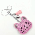 Pink rhinestone cartoon cat head keychain with leather tassel and small silver bell charm - Pink