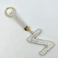 Detailed view of capital letter Z keychain with white rhinestones and golden spring clasp - Style Z