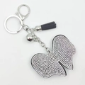 Porte-clés nœud papillon en strass avec pompon en cuir et cloche argentée - Blanc