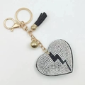 Detail view of heart keychain with white rhinestones, black lightning pattern and tassel - Black with White