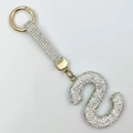 Detailed close-up of a golden capital letter S keychain with sparkling crystal rhinestones - Style S