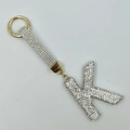 Close-up of sparkling rhinestone-encrusted letter K keychain with golden hardware and strap - Style K