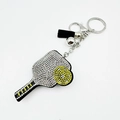 Sparkly rhinestone cricket racket keychain with black tassel and silver bell for bags - White