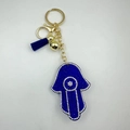 Macro detail of Hamsa Hand keychain with blue rhinestones and leather tassel - Hamsa Hand Style - Gold