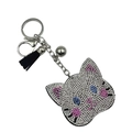 Sparkly rhinestone cat head keychain with blue eyes, metal bell and black tassel - White