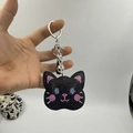 Sparkling black rhinestone cat head keychain with blue eyes and pink ear accents - Black