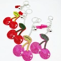 Detail of crystal cherry keychain with vibrant rhinestones, colorful tassels, and bells - Customizable Color
