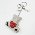 Sparkling crystal cartoon bear keychain with red heart and white tassel on white background - White