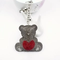 Detailed close-up of grey crystal bear keychain with red heart and silver metal link - Gray