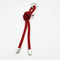 Close-up of red rhinestone cord keychain with silver heart pendant and metal ring - Red