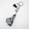 Sparkling crystal lipstick keychain with red rhinestones and black tassel accessory - Lake Blue